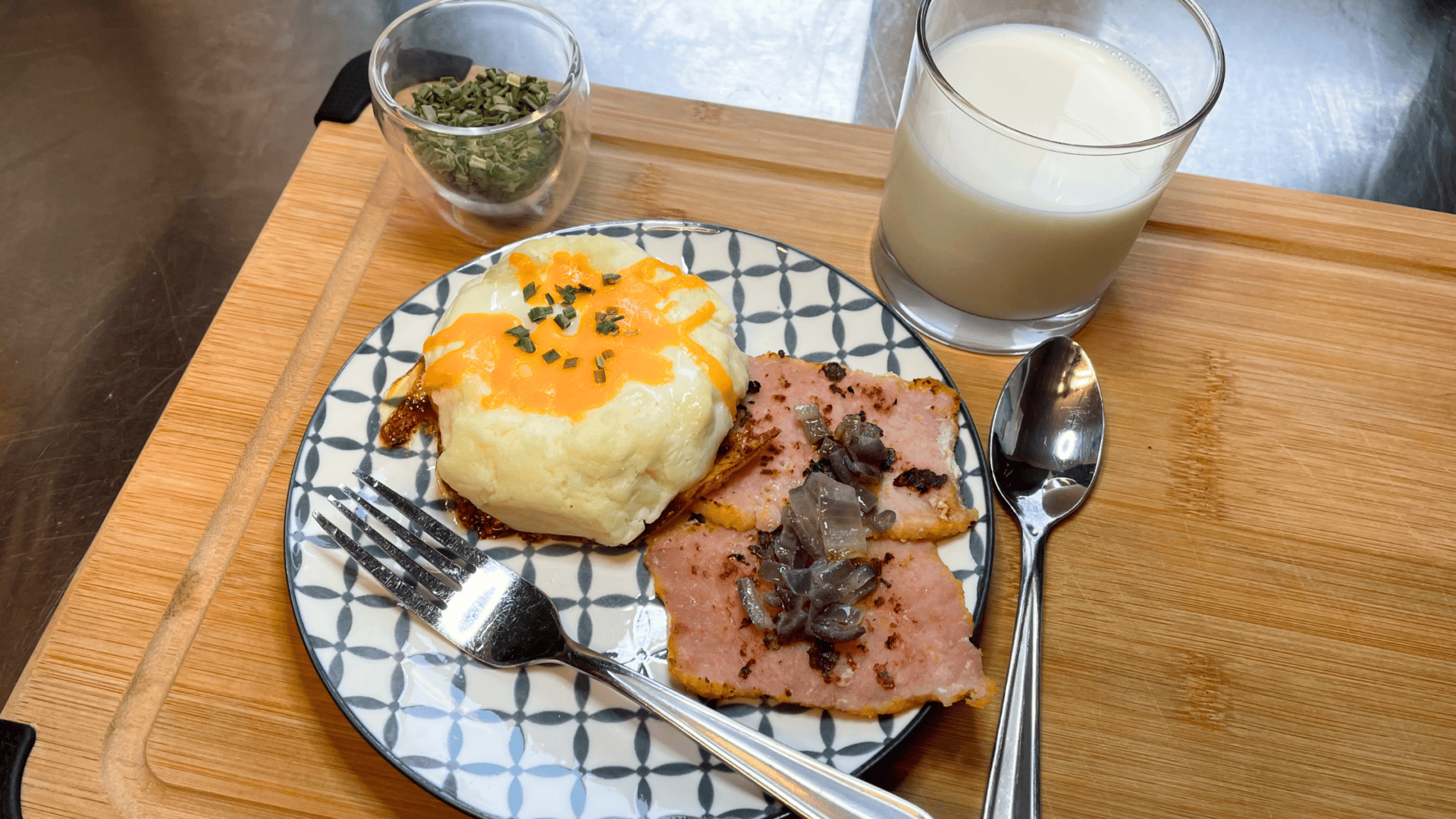 fried egg peameal bacon glass of milk spoon fork