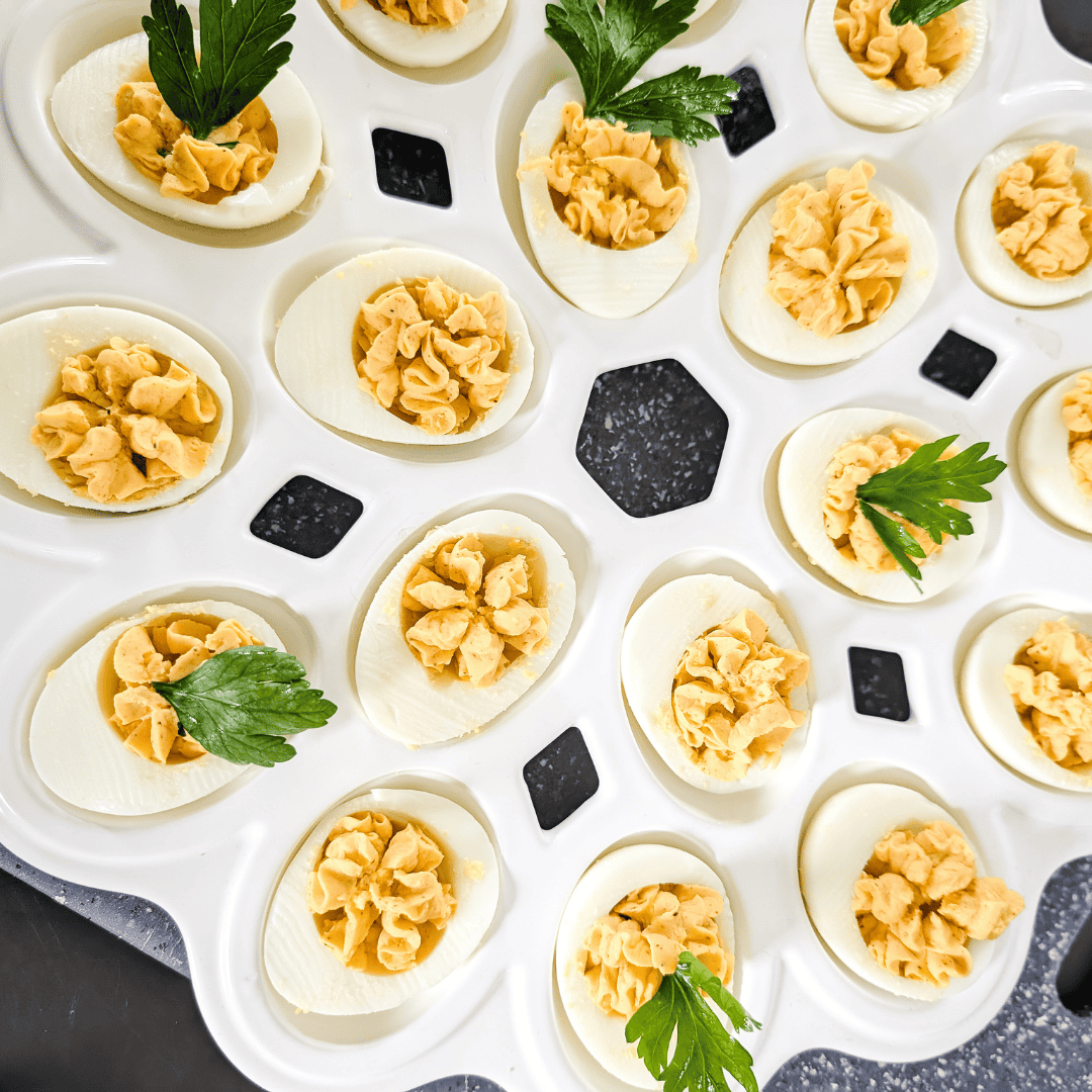 Deviled eggs with parsley garnish.