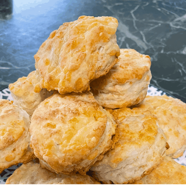 jalapeno cheese biscuits stacked on plate black marble table behind