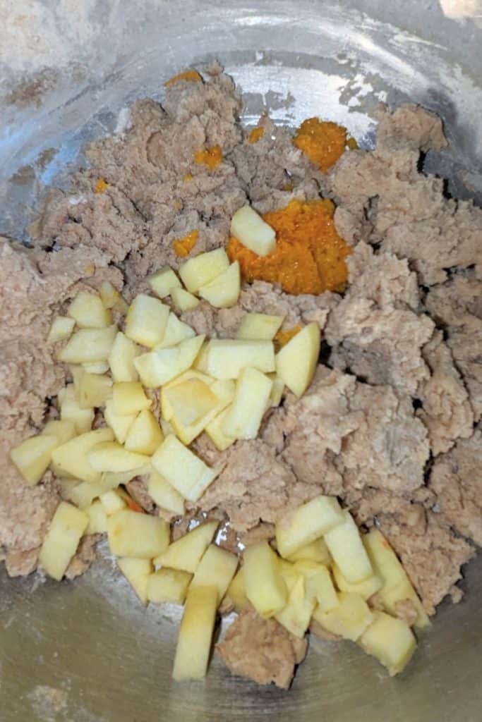 adding chopped apple and orange zest to wassail cookie batter