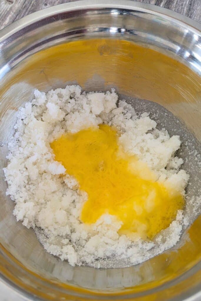 adding beaten egg to oil sugar mixture