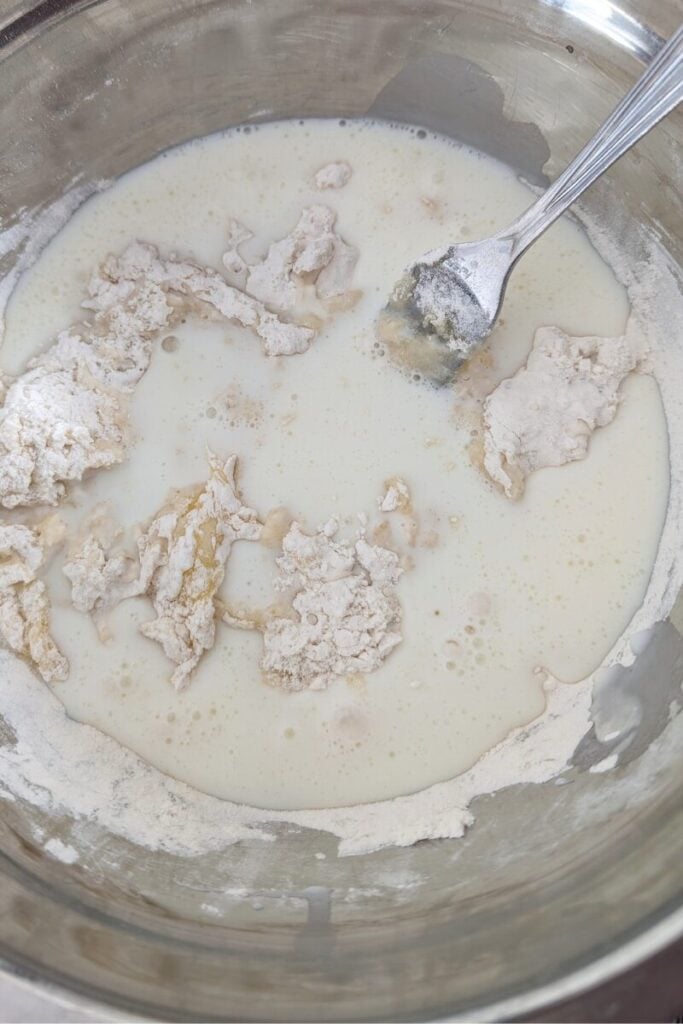 adding remaining mix into the cupcake batter