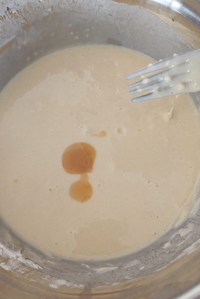 adding the pistachio emulsion to the cupcake batter