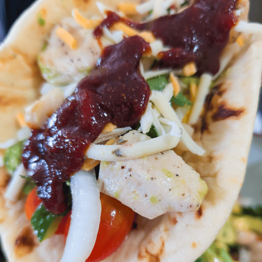 Delicious BBQ chicken wraps with fresh vegetables and savory sauce. Perfect for a quick, flavorful m.