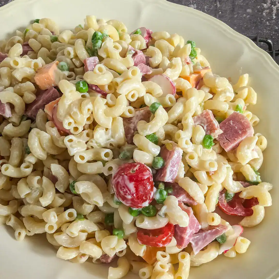 Creamy macaroni salad on cream colored plate