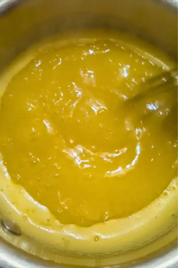 boiling orange juice in saucepan