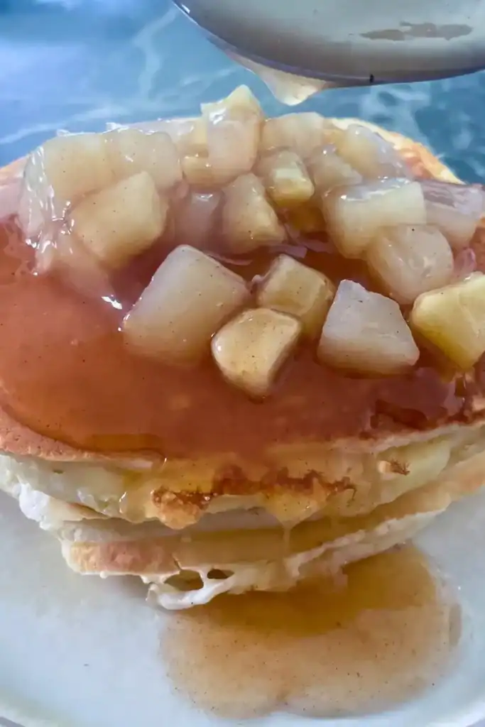 the apple cinnamon pear compote on a stack of fluffy buttermilk pancakes