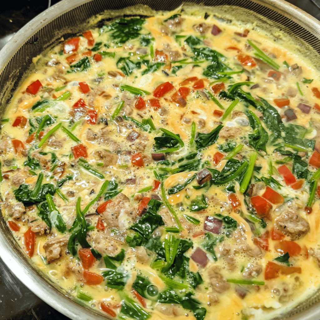 Delicious sausage and spinach frittata with colorful vegetables, perfect for breakfast or brunch.