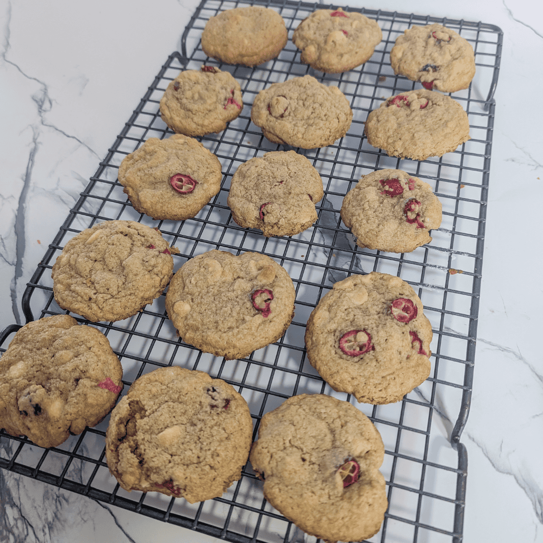Buttery cherry oatmeal cookies cooling on a wire rack.