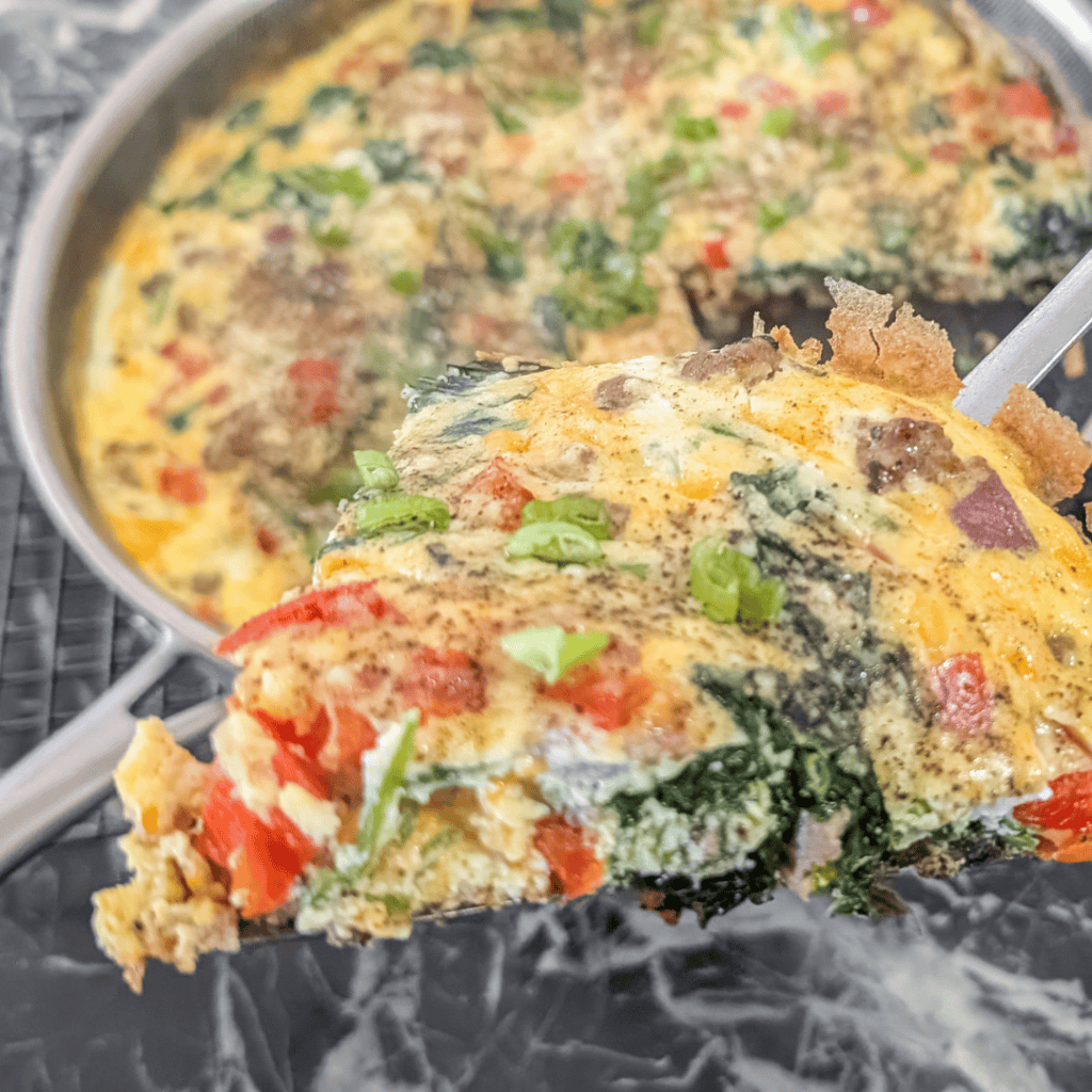 Delicious sausage and spinach frittata with colorful vegetables and fluffy eggs.