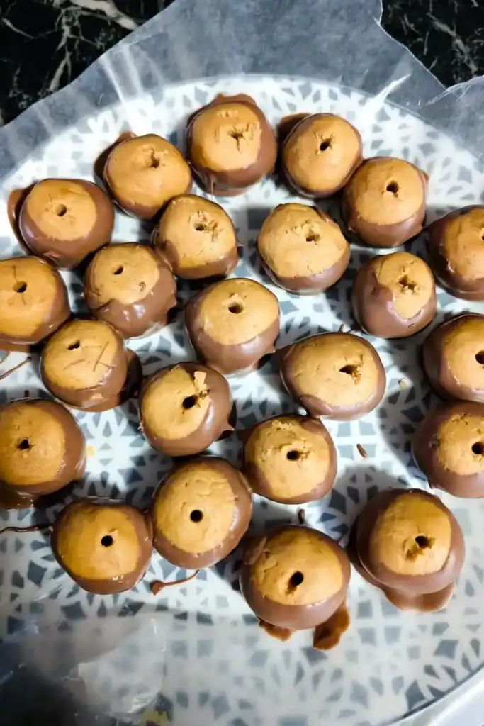 all the wowbutter balls dipped in chocolate on wax paper on plate