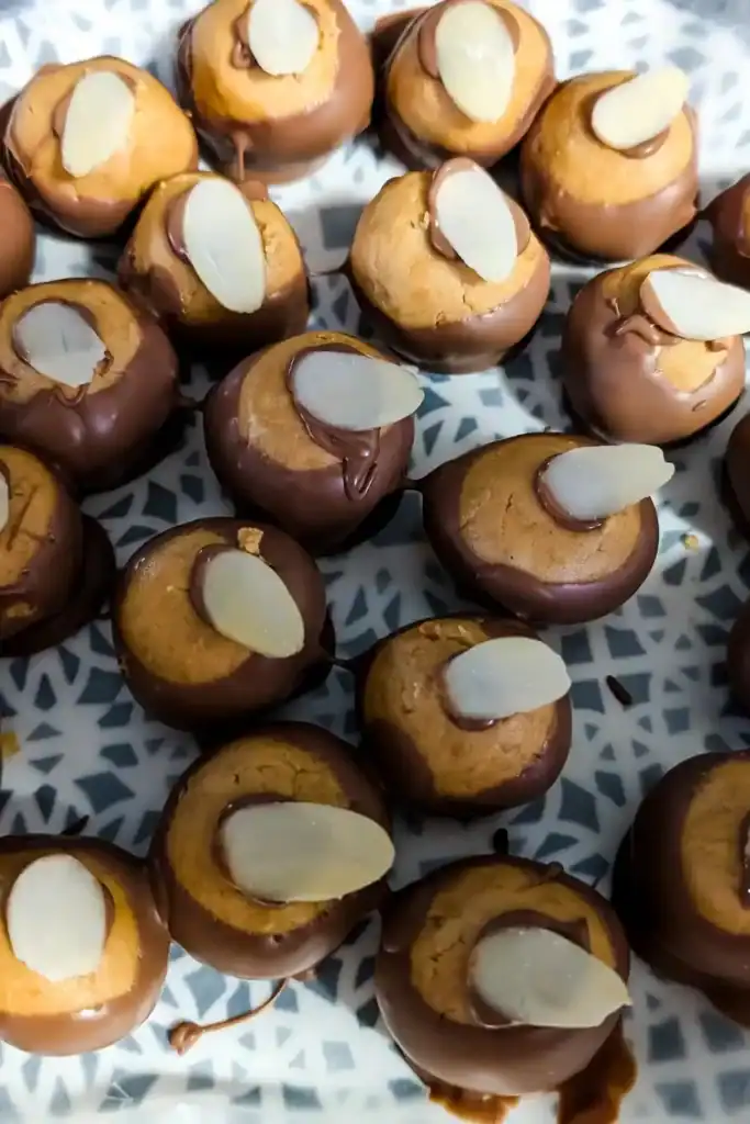 adding the sliced almonds to the balls to cover holes