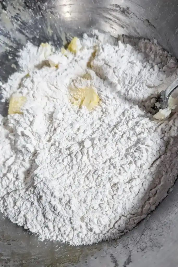 adding flour and salt to creamed butter mixture