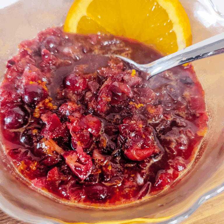Sweet cherry compote with fresh orange slices, perfect for desserts or breakfast toppings.