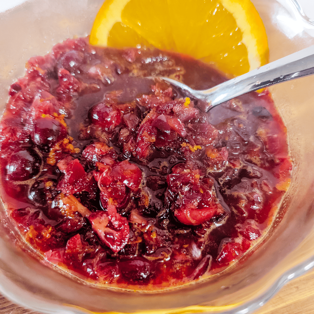 Sweet cherry compote with fresh orange slices, perfect for desserts or breakfast toppings.