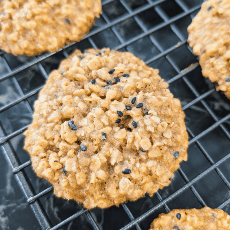 Delicious chewy oatmeal cookies topped with black sesame seeds, perfect for a cozy treat or dessert.