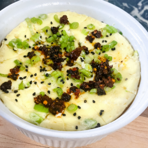 Mashed potatoes topped with green onions, black sesame seeds, and crispy fried garlic.