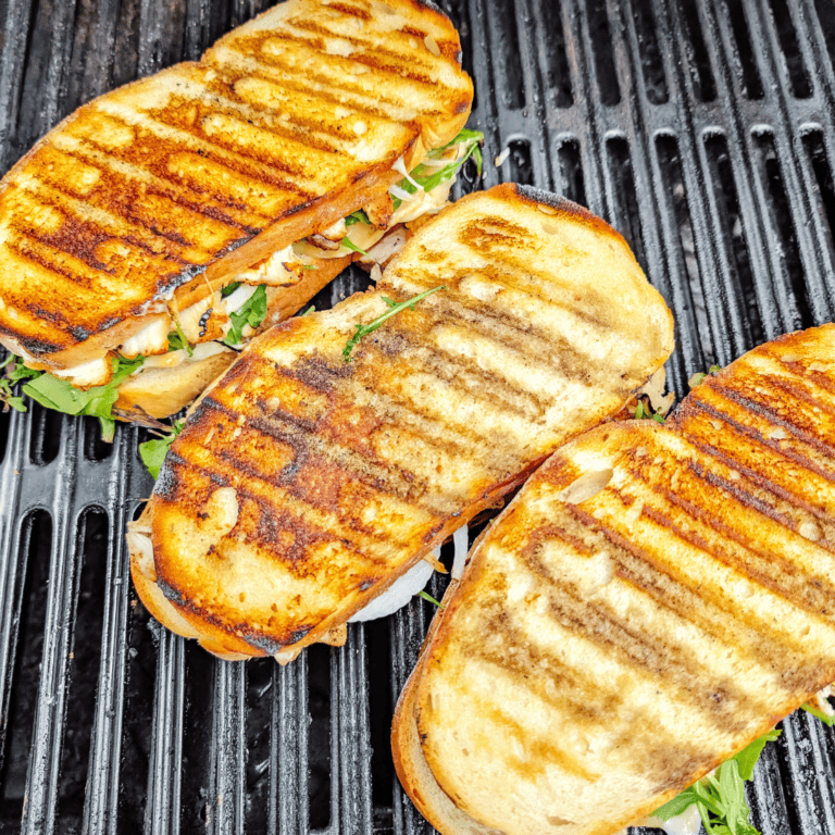 Delicious grilled chicken sandwiches with fresh greens on toasted bread, perfect for lunch or dinner.