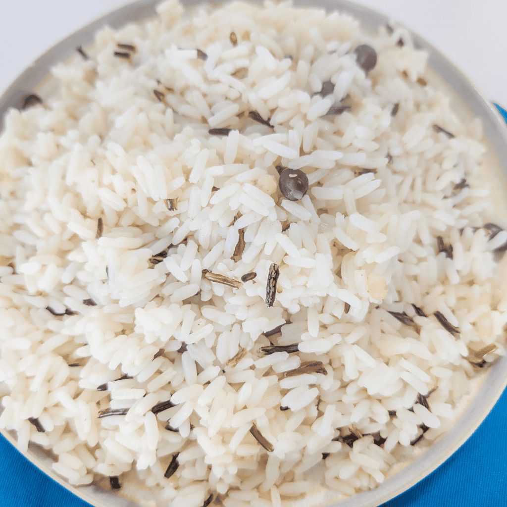 Fragrant steamed rice with herbs and spices, close-up view.