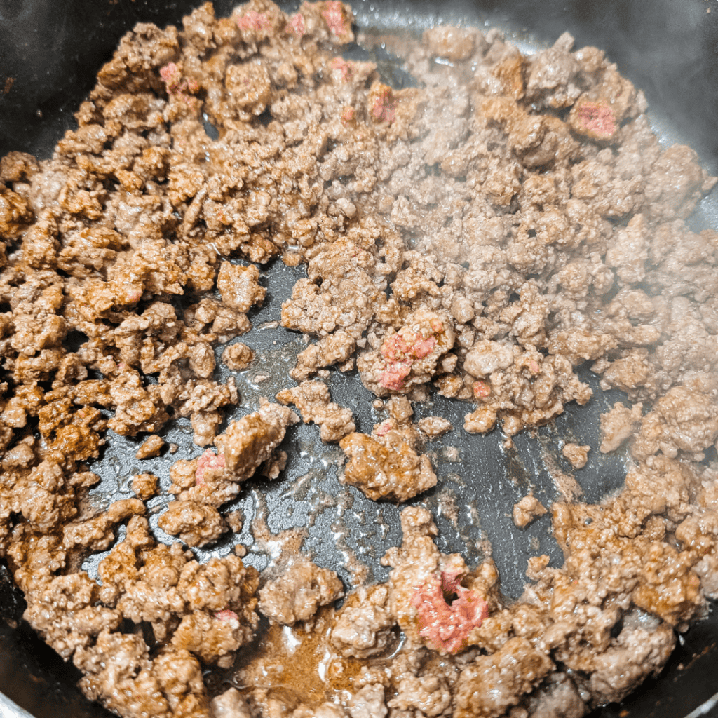 Ground beef cooking in a skillet for homemade taco meat recipe.